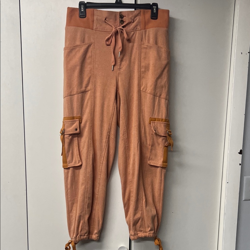 Free People light orange joggers with tie at waist and ankles.